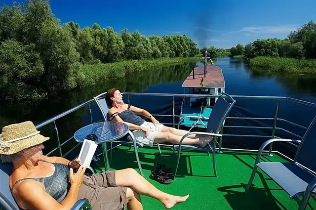 Birdwatching from the Ibis Tours floating hotel — sunrise on the Danube Delta channels